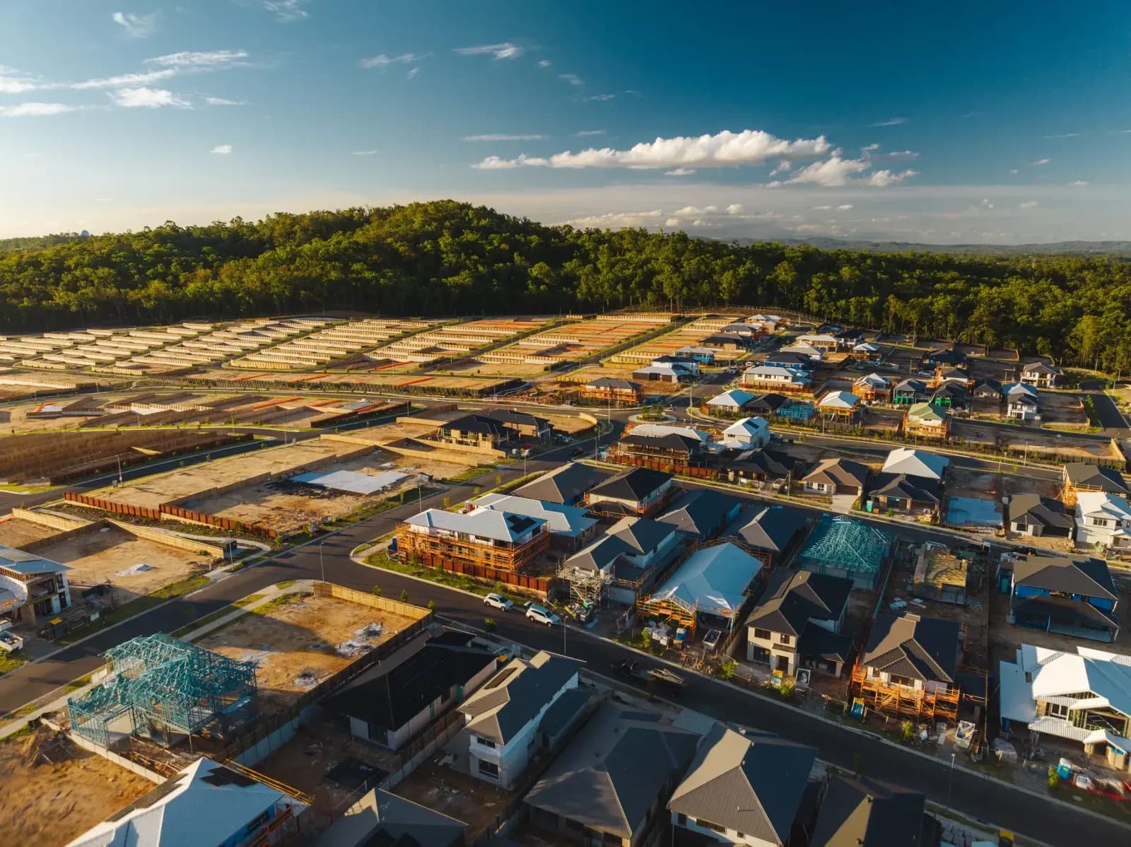 Aerial view of new-build homes with solar installation in progress